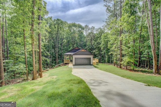 48 Bluejay Ct, Monticello, GA 31064 - view of front of home with a forest view, driveway, a front yard, and a garage