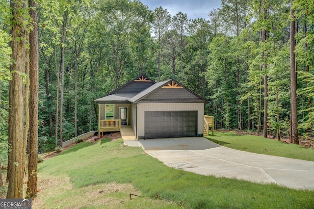 48 Bluejay Ct, Monticello, GA 31064 - view of front of house with an attached garage, a view of trees, a front yard, concrete driveway, and covered porch