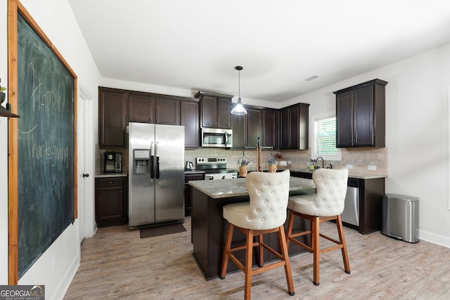 470 Louise Way, Locust Grove, GA 30248 - kitchen with appliances with stainless steel finishes, dark brown cabinets, tasteful backsplash, and light wood-type flooring