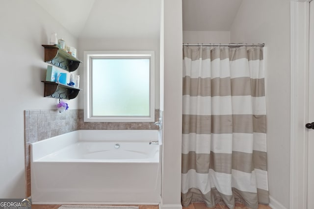 470 Louise Way, Locust Grove, GA 30248 - full bathroom featuring a garden tub, a shower with shower curtain, and vaulted ceiling