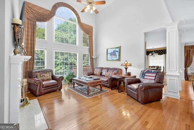 2002 Ivy Ridge Rd SE, Smyrna, GA 30080 - living room featuring ornate columns, light wood-type flooring, plenty of natural light, high vaulted ceiling, and ceiling fan