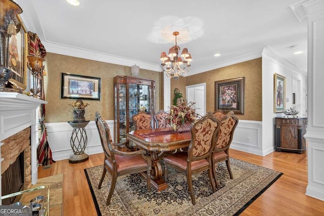 2002 Ivy Ridge Rd SE, Smyrna, GA 30080 - dining room with a chandelier, a fireplace with flush hearth, wainscoting, light wood-type flooring, and recessed lighting
