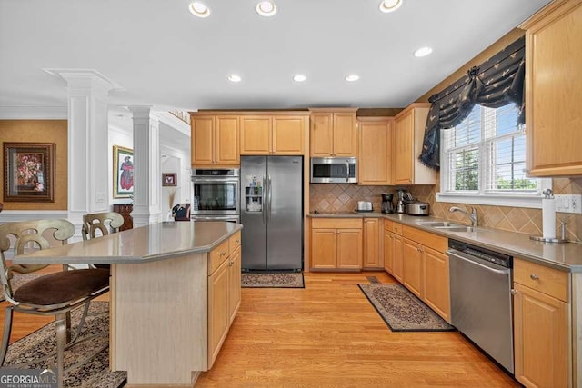 2002 Ivy Ridge Rd SE, Smyrna, GA 30080 - kitchen with appliances with stainless steel finishes, decorative columns, light brown cabinetry, recessed lighting, and crown molding