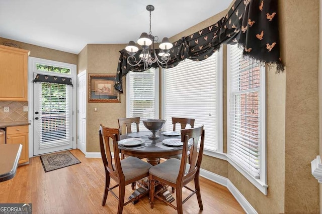 2002 Ivy Ridge Rd SE, Smyrna, GA 30080 - dining space featuring a chandelier and light wood-style flooring