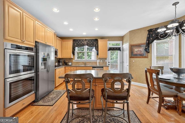 2002 Ivy Ridge Rd SE, Smyrna, GA 30080 - kitchen featuring stainless steel appliances, light wood-style floors, light brown cabinetry, a chandelier, and recessed lighting