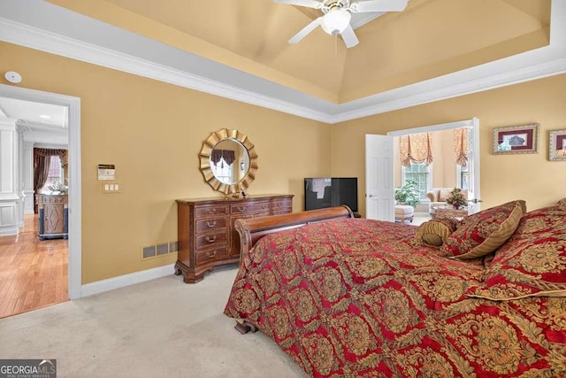 2002 Ivy Ridge Rd SE, Smyrna, GA 30080 - bedroom featuring ornamental molding, light carpet, a raised ceiling, and a ceiling fan