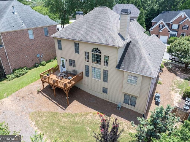 2002 Ivy Ridge Rd SE, Smyrna, GA 30080 - back of house with a chimney, a deck, and a shingled roof