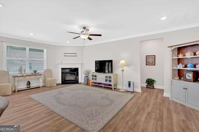 427 Bluffs View Ln, Canton, GA 30114 - living area with a ceiling fan, a fireplace with flush hearth, ornamental molding, light wood finished floors, and recessed lighting