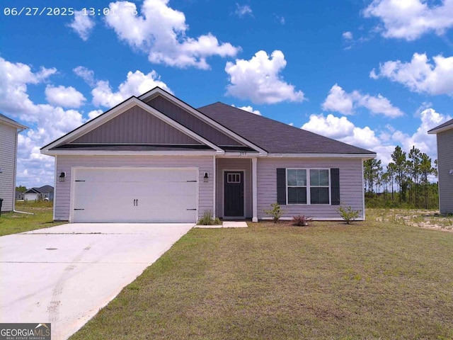 299 Mcclelland Loop NE, Ludowici, GA 31316 - view of front of house with concrete driveway, an attached garage, a front lawn, and board and batten siding