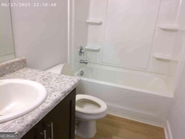 299 Mcclelland Loop NE, Ludowici, GA 31316 - bathroom with vanity, wood finished floors, and bathing tub / shower combination