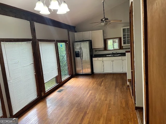 2917 Katherine Valley Rd, Decatur, GA 30032 - kitchen featuring stainless steel fridge with ice dispenser, lofted ceiling, hardwood / wood-style flooring, dark countertops, and a ceiling fan