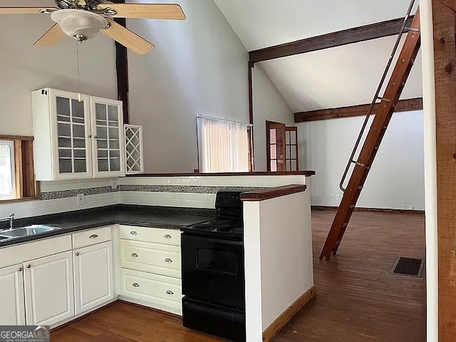 2917 Katherine Valley Rd, Decatur, GA 30032 - kitchen featuring electric range, dark countertops, decorative backsplash, a peninsula, and high vaulted ceiling