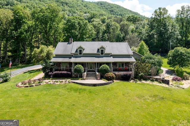 4167 Downings Creek Rd, Hayesville, NC 28904 - view of front of property with a forest view, a front lawn, covered porch, and a chimney