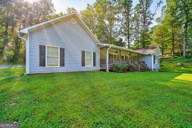 30 Red Bird Ln, Ellijay, GA 30540 - back of property featuring covered porch, a lawn, and a ceiling fan