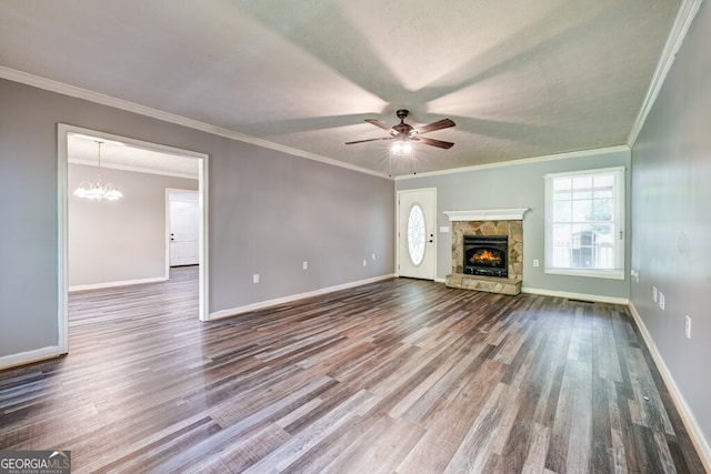 30 Red Bird Ln, Ellijay, GA 30540 - unfurnished living room featuring dark wood-type flooring, a stone fireplace, a ceiling fan, a chandelier, and ornamental molding