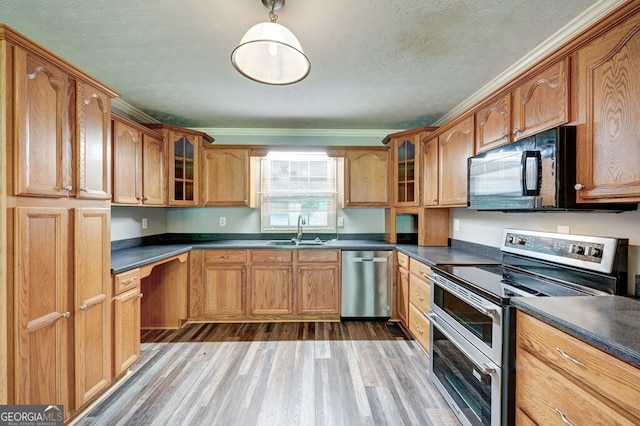30 Red Bird Ln, Ellijay, GA 30540 - kitchen with appliances with stainless steel finishes, wood finished floors, dark countertops, glass insert cabinets, and a textured ceiling