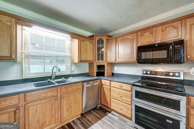 30 Red Bird Ln, Ellijay, GA 30540 - kitchen with appliances with stainless steel finishes, crown molding, wood finished floors, glass insert cabinets, and dark countertops