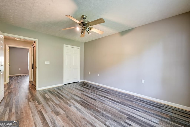 30 Red Bird Ln, Ellijay, GA 30540 - unfurnished bedroom featuring wood finished floors, a closet, and a ceiling fan