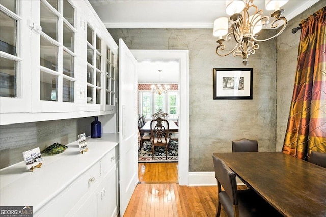 3579 Overlook Ave, Macon, GA 31204 - dining space with a chandelier, light wood-style flooring, and crown molding