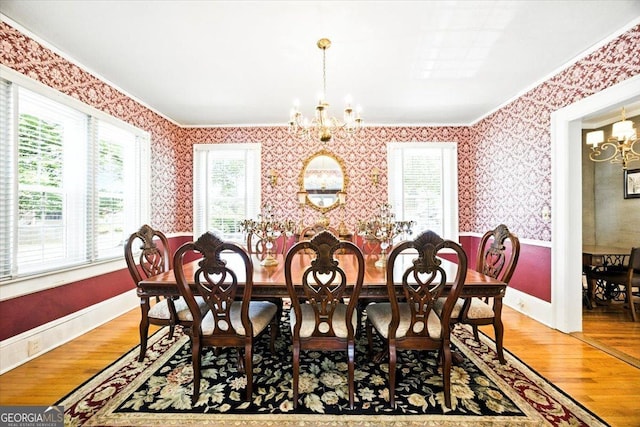 3579 Overlook Ave, Macon, GA 31204 - dining space featuring a chandelier, wallpapered walls, crown molding, plenty of natural light, and light wood-type flooring