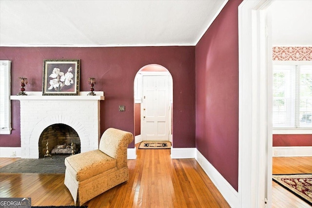 3579 Overlook Ave, Macon, GA 31204 - living room featuring hardwood / wood-style flooring, arched walkways, and a brick fireplace