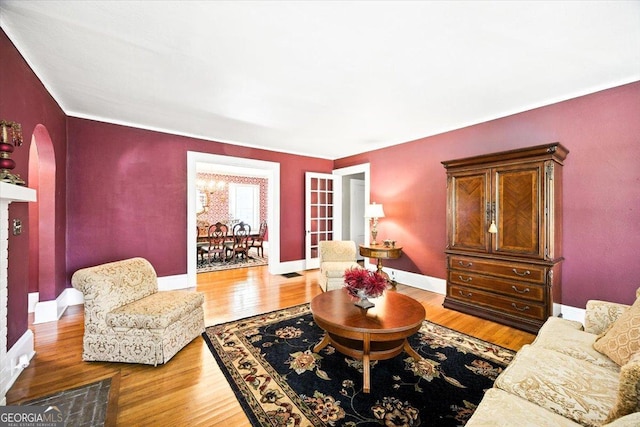3579 Overlook Ave, Macon, GA 31204 - living area with wood finished floors, arched walkways, and crown molding