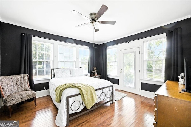 3579 Overlook Ave, Macon, GA 31204 - bedroom with crown molding, wood-type flooring, multiple windows, access to exterior, and ceiling fan