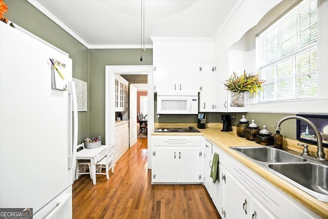 3579 Overlook Ave, Macon, GA 31204 - kitchen with white appliances, healthy amount of natural light, wood finished floors, white cabinets, and ornamental molding