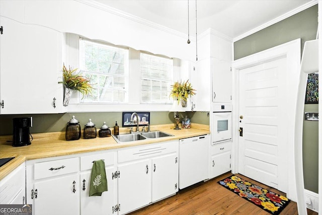3579 Overlook Ave, Macon, GA 31204 - kitchen featuring white appliances, crown molding, light countertops, white cabinets, and wood finished floors