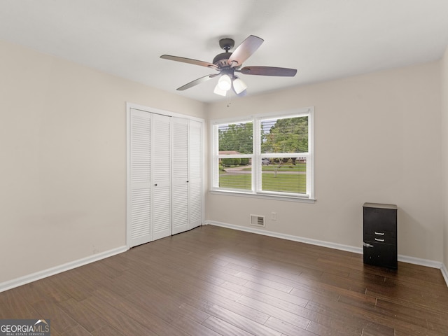 117 Thomas St, Griffin, GA 30224 - unfurnished bedroom with a closet, wood finished floors, and a ceiling fan