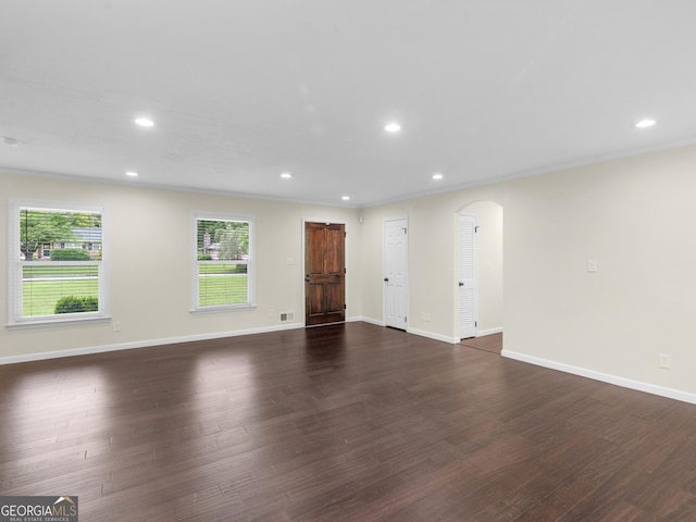 117 Thomas St, Griffin, GA 30224 - empty room with arched walkways, dark wood finished floors, and recessed lighting