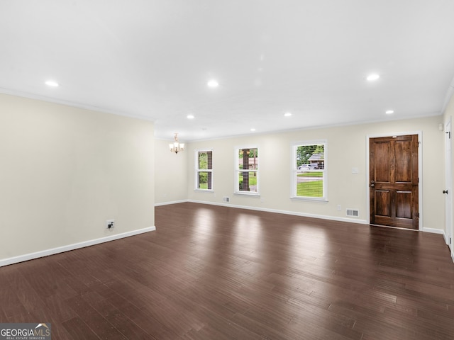 117 Thomas St, Griffin, GA 30224 - unfurnished living room with a chandelier, ornamental molding, dark wood finished floors, and recessed lighting
