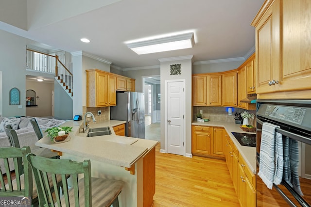801 Windsor Rdg, Canton, GA 30115 - kitchen with black appliances, a peninsula, ornamental molding, light countertops, and light wood-style floors