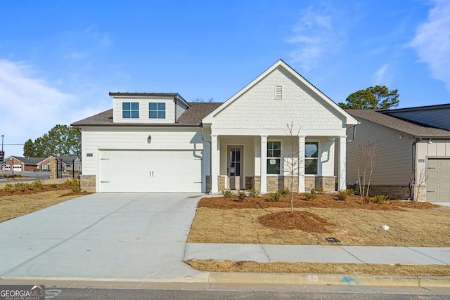 1692 Juniper Berry Way, Loganville, GA 30052 - craftsman-style home with stone siding, a porch, driveway, and a garage