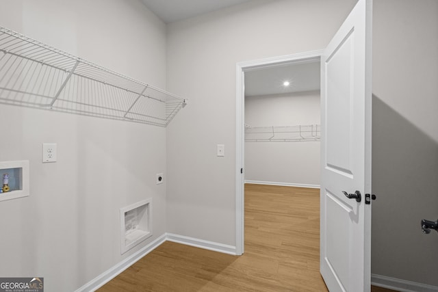 1692 Juniper Berry Way, Loganville, GA 30052 - laundry area featuring hookup for an electric dryer, light wood-style flooring, and hookup for a washing machine