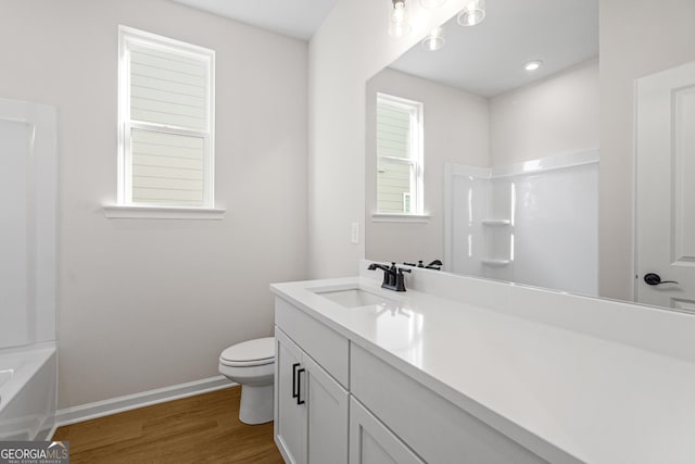 1692 Juniper Berry Way, Loganville, GA 30052 - bathroom with vanity, wood finished floors, and washtub / shower combination