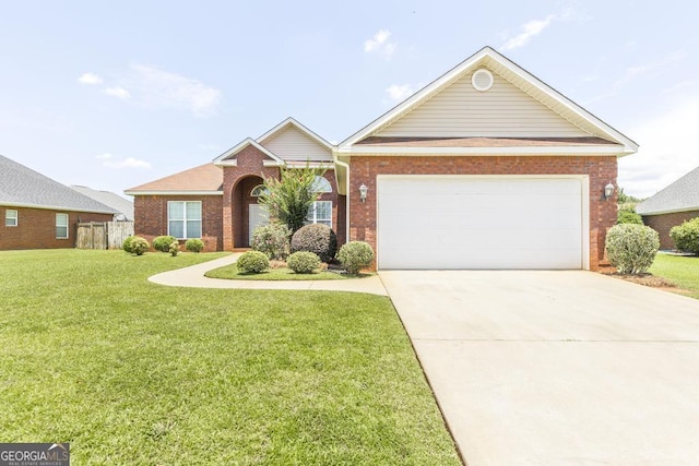 112 Huntwood Ln, Kathleen, GA 31047 - view of front of house featuring a front yard, brick siding, driveway, and an attached garage