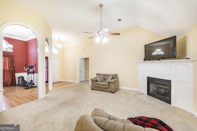 112 Huntwood Ln, Kathleen, GA 31047 - living room with ceiling fan, arched walkways, a fireplace with flush hearth, carpet, and vaulted ceiling