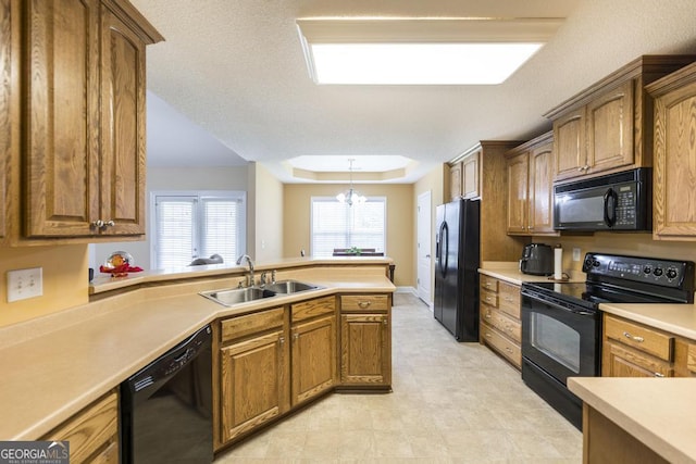 112 Huntwood Ln, Kathleen, GA 31047 - kitchen with black appliances, a raised ceiling, brown cabinets, and light countertops
