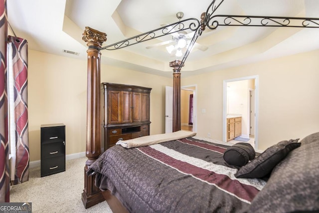 112 Huntwood Ln, Kathleen, GA 31047 - bedroom with ornate columns, a raised ceiling, light colored carpet, ensuite bath, and a ceiling fan