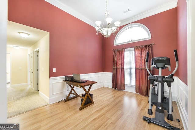112 Huntwood Ln, Kathleen, GA 31047 - exercise room featuring wainscoting, a chandelier, ornamental molding, wood finished floors, and a decorative wall