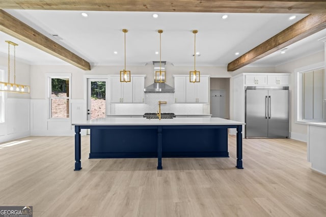 1131 Glen Eagle Dr, Greensboro, GA 30642 - kitchen featuring built in fridge, wall chimney range hood, beam ceiling, white cabinets, and light countertops