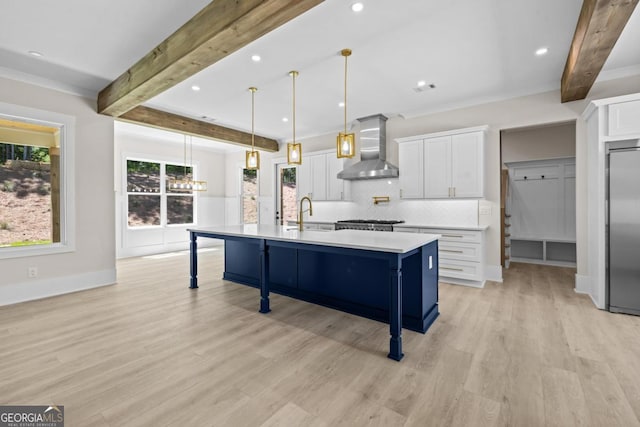 1131 Glen Eagle Dr, Greensboro, GA 30642 - kitchen featuring wall chimney range hood, beamed ceiling, stainless steel fridge, white cabinetry, and light countertops
