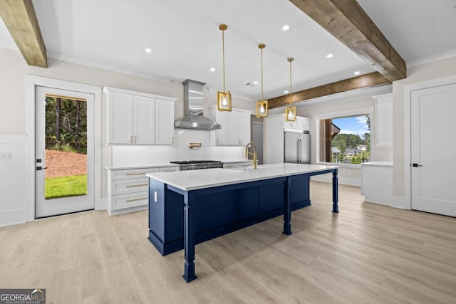 1131 Glen Eagle Dr, Greensboro, GA 30642 - kitchen with wall chimney range hood, high quality fridge, beamed ceiling, light wood finished floors, and light countertops