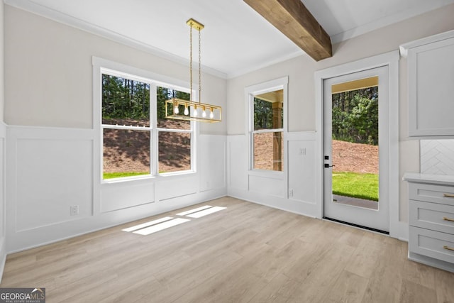 1131 Glen Eagle Dr, Greensboro, GA 30642 - unfurnished dining area featuring plenty of natural light, beam ceiling, light wood-type flooring, a wainscoted wall, and a chandelier