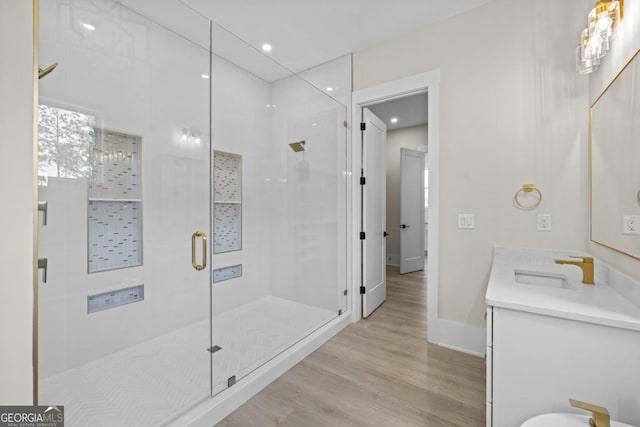 1131 Glen Eagle Dr, Greensboro, GA 30642 - full bath with wood finished floors, a stall shower, vanity, and recessed lighting