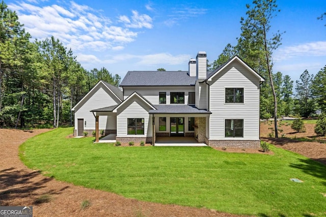 1131 Glen Eagle Dr, Greensboro, GA 30642 - rear view of property with a patio area, a chimney, a lawn, and roof with shingles