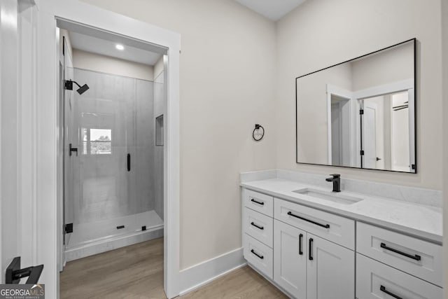 1131 Glen Eagle Dr, Greensboro, GA 30642 - full bathroom with a stall shower, vanity, and wood finished floors
