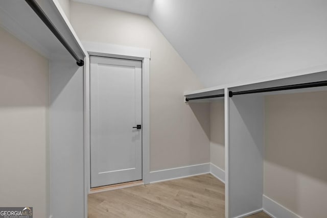 1131 Glen Eagle Dr, Greensboro, GA 30642 - spacious closet with light wood-style flooring and vaulted ceiling