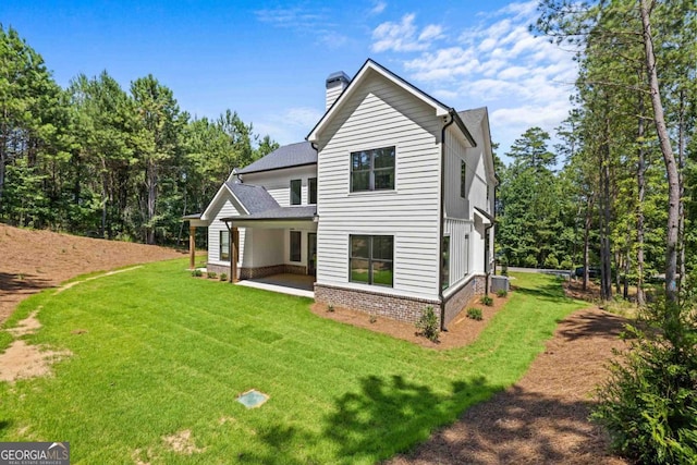 1131 Glen Eagle Dr, Greensboro, GA 30642 - rear view of property with a chimney, a lawn, a patio, and roof with shingles